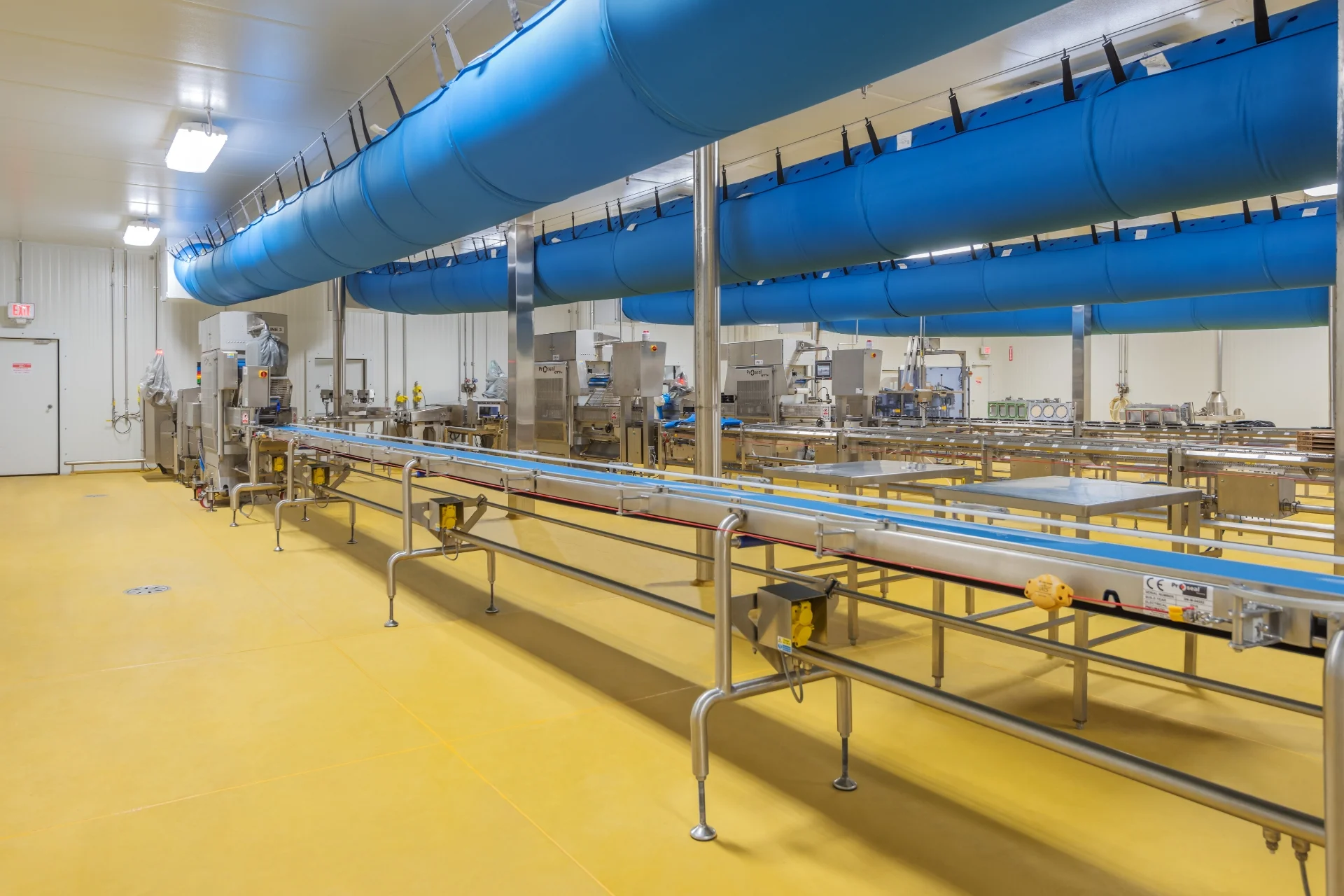 yellow manufacturing floor with machinery and tubing