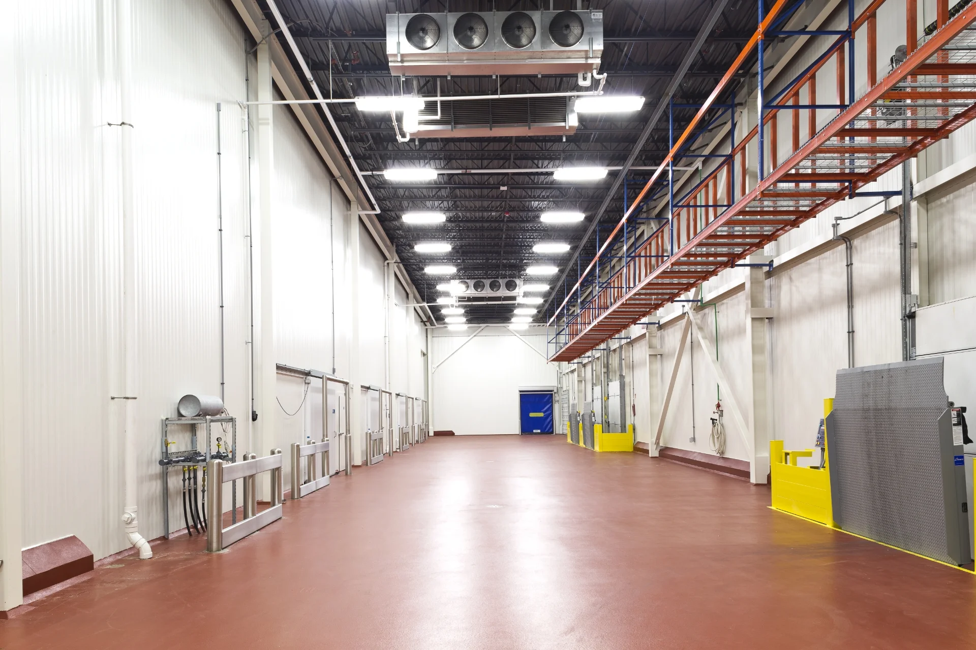 hallway with red floor and control panels